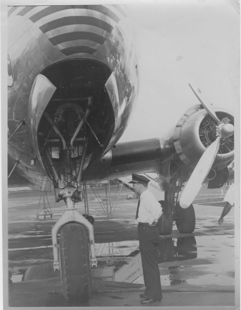 1948 A Pan Am  pilot by the nose wheel of a DC4 aircraft.